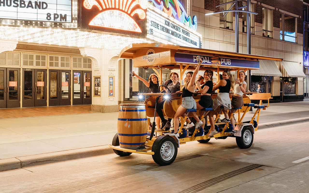 Happy riding on a Pedal Pub bike at night