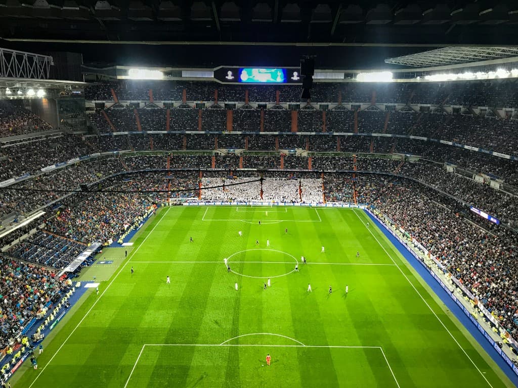 A packed football stadium at night
