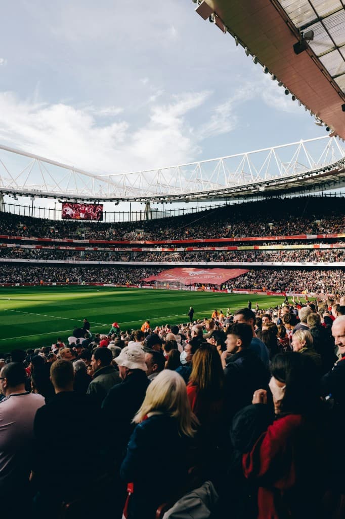 A daytime view from the stands across a packed football stadium