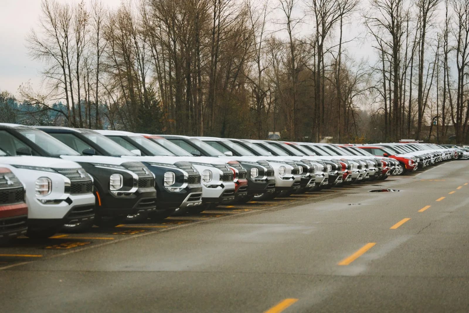 A row of new SUVs parked in an outdoor lot