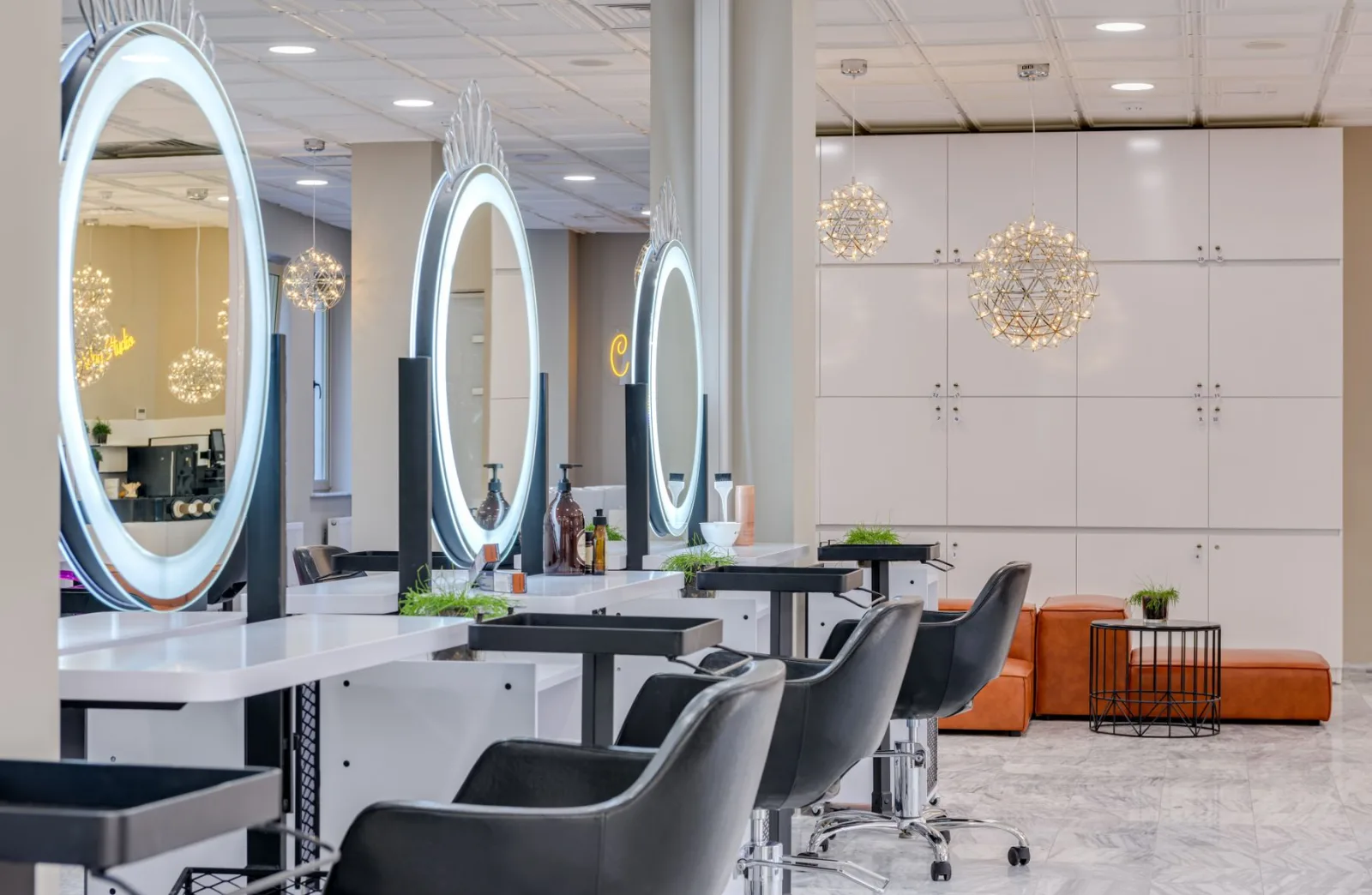 A bright salon with styling chairs and round mirrors