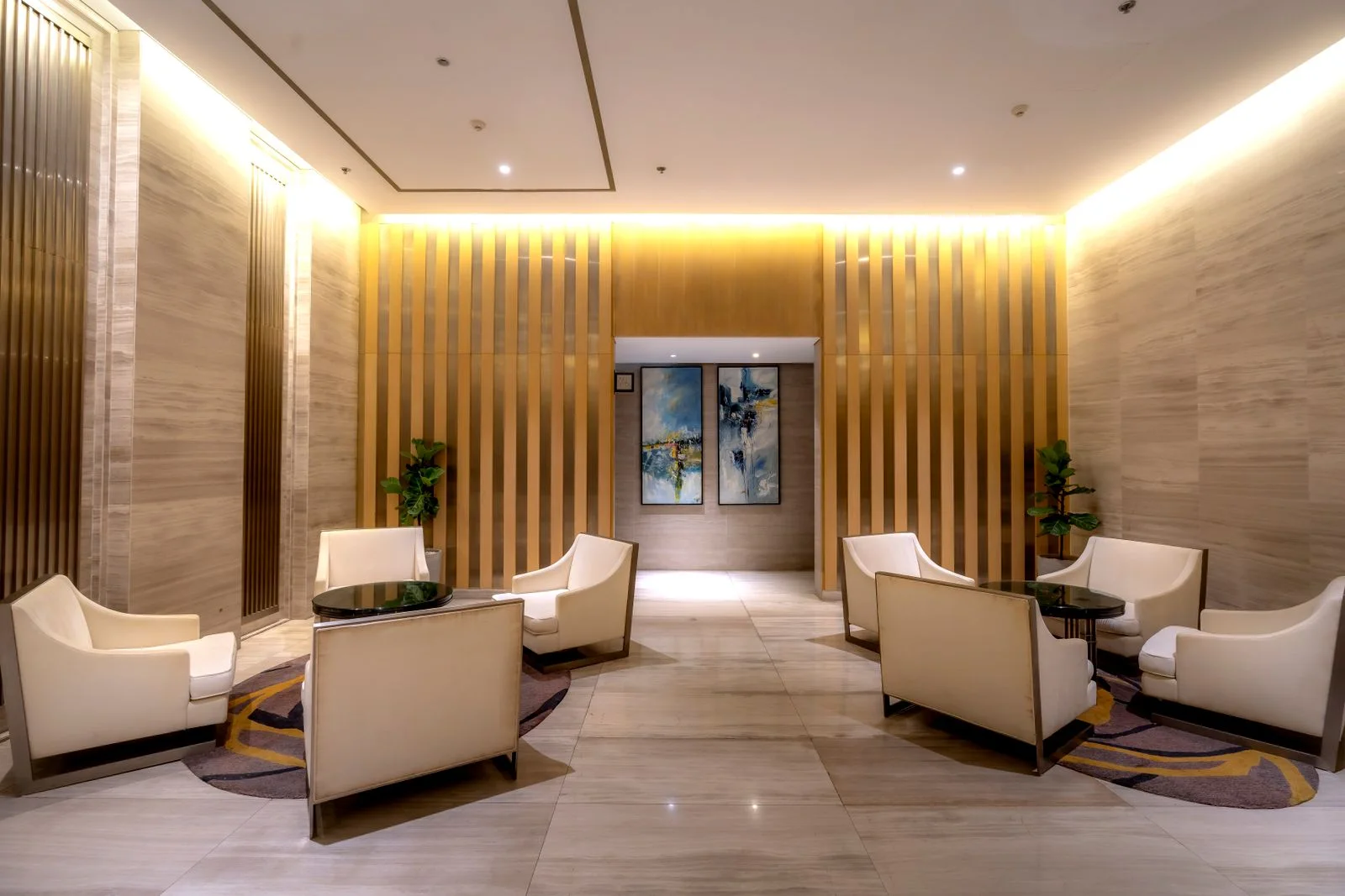 Warm contemporary hotel lounge with sculptural wood details and comfortable seating