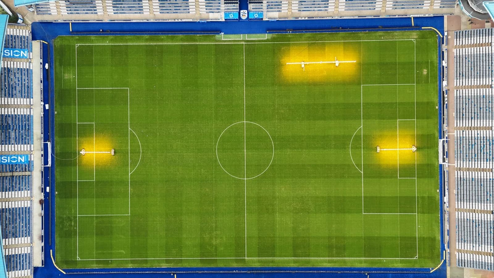 An overhead view of a football stadium, with the pitch surrounded by tiers of seating